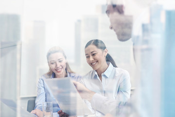 group of smiling businesspeople meeting in office