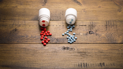 Scattered from medical bottle red and blue pills