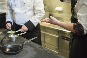 Cooks working next to the oven