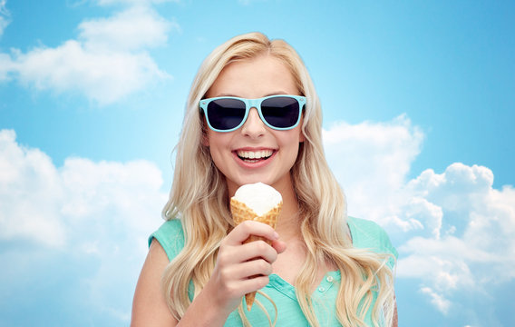 happy young woman in sunglasses eating ice cream