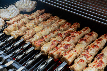 fresh hot grilled chicken shish kebab barbecue on grid over 