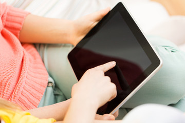 close up of young women with tablet pc at home