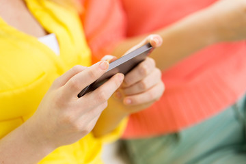 close up of woman texting on smartphone at home