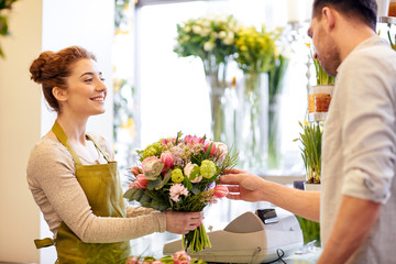smiling florist woman and man at flower shop