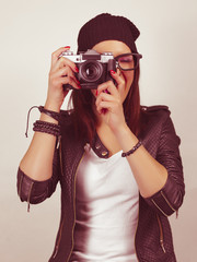 Hipster girl taking a picture with old vintage camera. On green screen