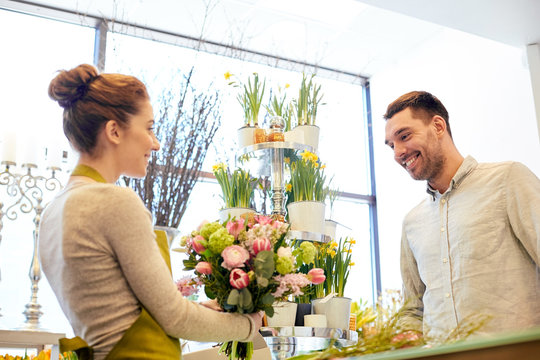 Smiling Florist Woman And Man At Flower Shop