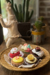 Mixed cupcakes on wood table.