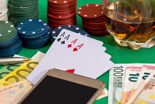 Poker chips, cards  and euro bills with cognac glass