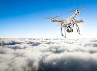 Fototapeta na wymiar Drone for industrial works flying above clouds