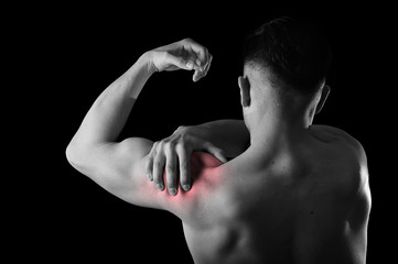 Fototapeta na wymiar young muscular sport man holding sore shoulder in pain touching massaging in workout stress