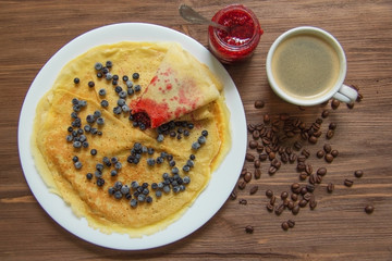 pancakes with blueberries and jam and coffee