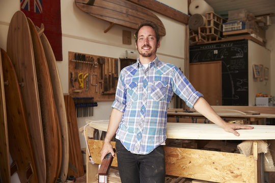 Portrait Of Carpenter In Bespoke Surfboard Workshop