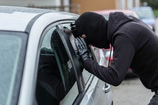 Car Thief Looking Through Car Window