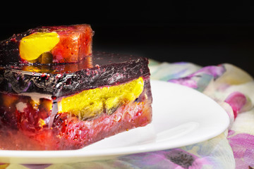 Colorful jelly cake with a variety of fruits in a  plate