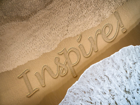 Inspire written on the beach