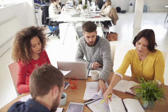 High Angle View Of Business Meeting In Modern Busy Office