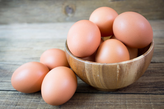 Eggs in paper tray on wood background