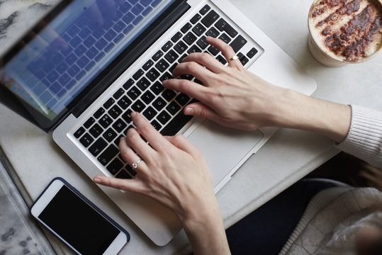 Overhead view of a woman using a laptop