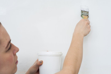 Woman with paint can and brush