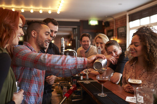Man Learning How To Mix Cocktail At Lesson In Bar