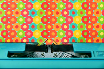 colorful circles-patterned paper in a blue typewriter