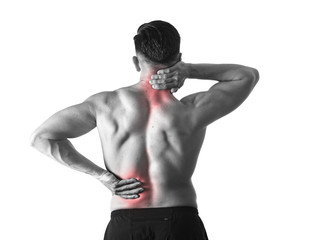 back view of young man with muscular body holding his neck and low back suffering spinal pain