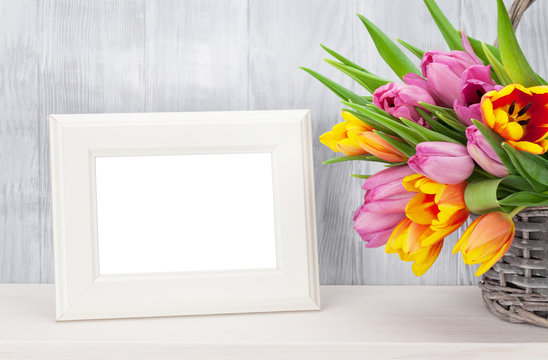 Fresh colorful tulips bouquet and photo frame
