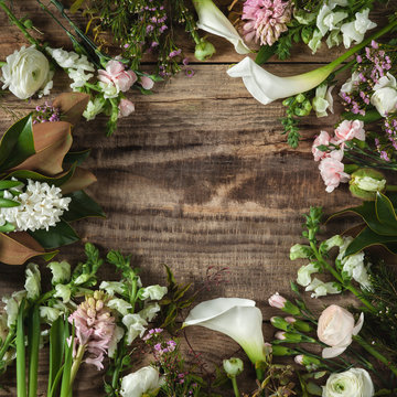 Frame from flowers on wooden background