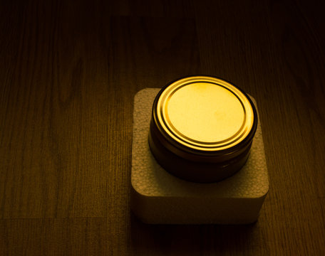 Illuminated jar lid in dark background