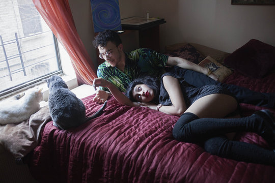 Young couple lying together in bed