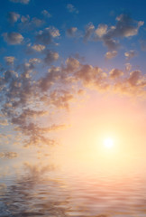 Calm sea, golden clouds and the last rays of the sun.