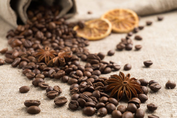 Coffee beans, cinnamon, star anise, orange dry on sackcloth