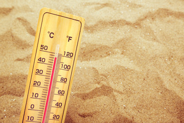 Extremely high temperatures, thermometer on warm desert sand