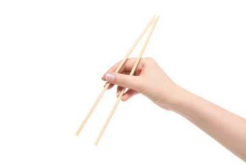 Female hand holds chopsticks on a white background.