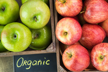 Assorted farm organic apples in crates.