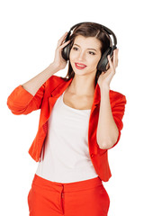 young woman dancing and listening music. emotions, facial expressions, feelings, body language, signs. image on a black studio background