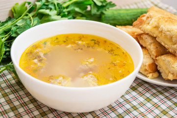 Soup with meatballs and toast with cheese