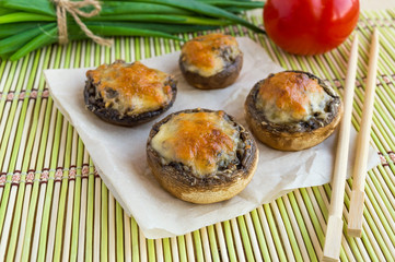 Baked stuffed mushrooms on a bamboo napkin. Vegetarian diets.