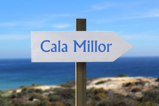 Cala Millor sign with seashore in the background