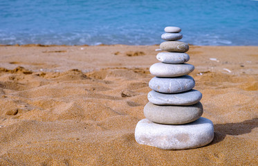 Fototapeta na wymiar Stack of stones on sea beach