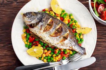 Sea bream baked with herbs and lemon, vegetable mix. 