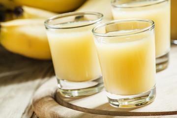 Freshly squeezed banana juice, vintage wooden background, select