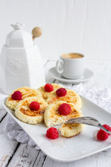 Homemade cottage cheese pancakes with raspberries and honey