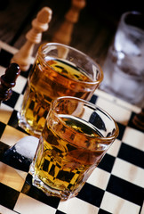 Cold brandy on a chess board, selective focus