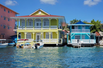 Typical Caribbean colonial homes over the water with boats at dock, Panama, Central America