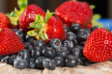 Plate full of fresh blueberries and strawberries