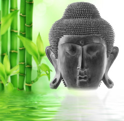 Front view of Buddha's face on bamboo background