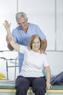 Physical therapist helps an elder patient