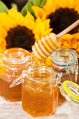 Fresh honey with colorful yellow sunflowers