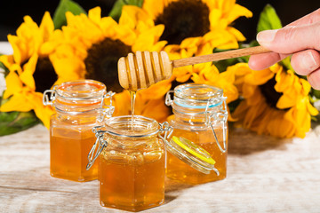 Fresh honey with colorful yellow sunflowers